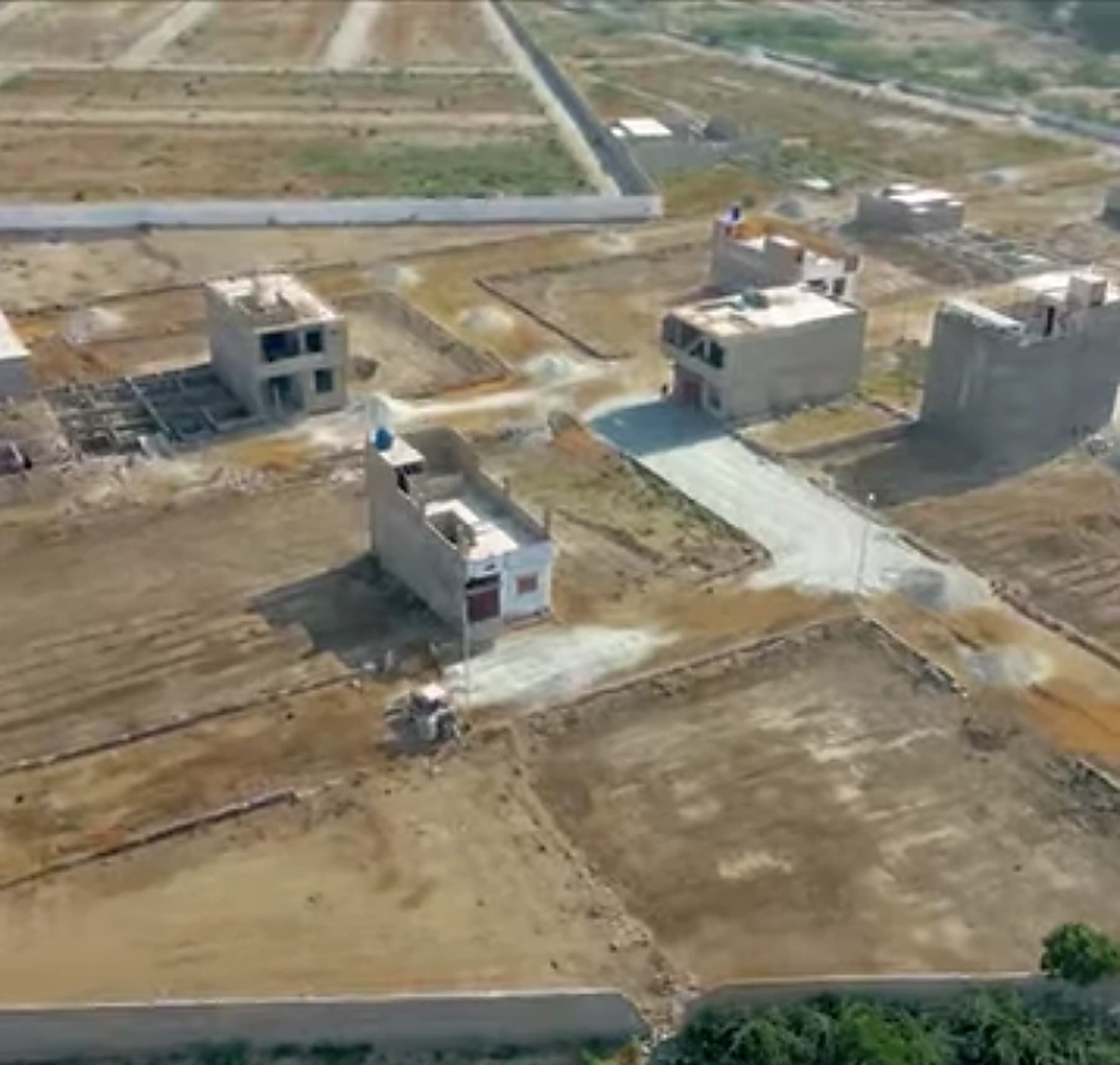 Aerial view of Emaan Housing plots with houses under construction.
