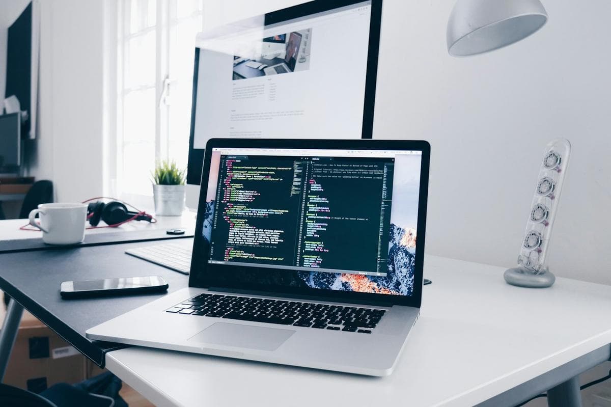 A laptop on a desk in a software studio.